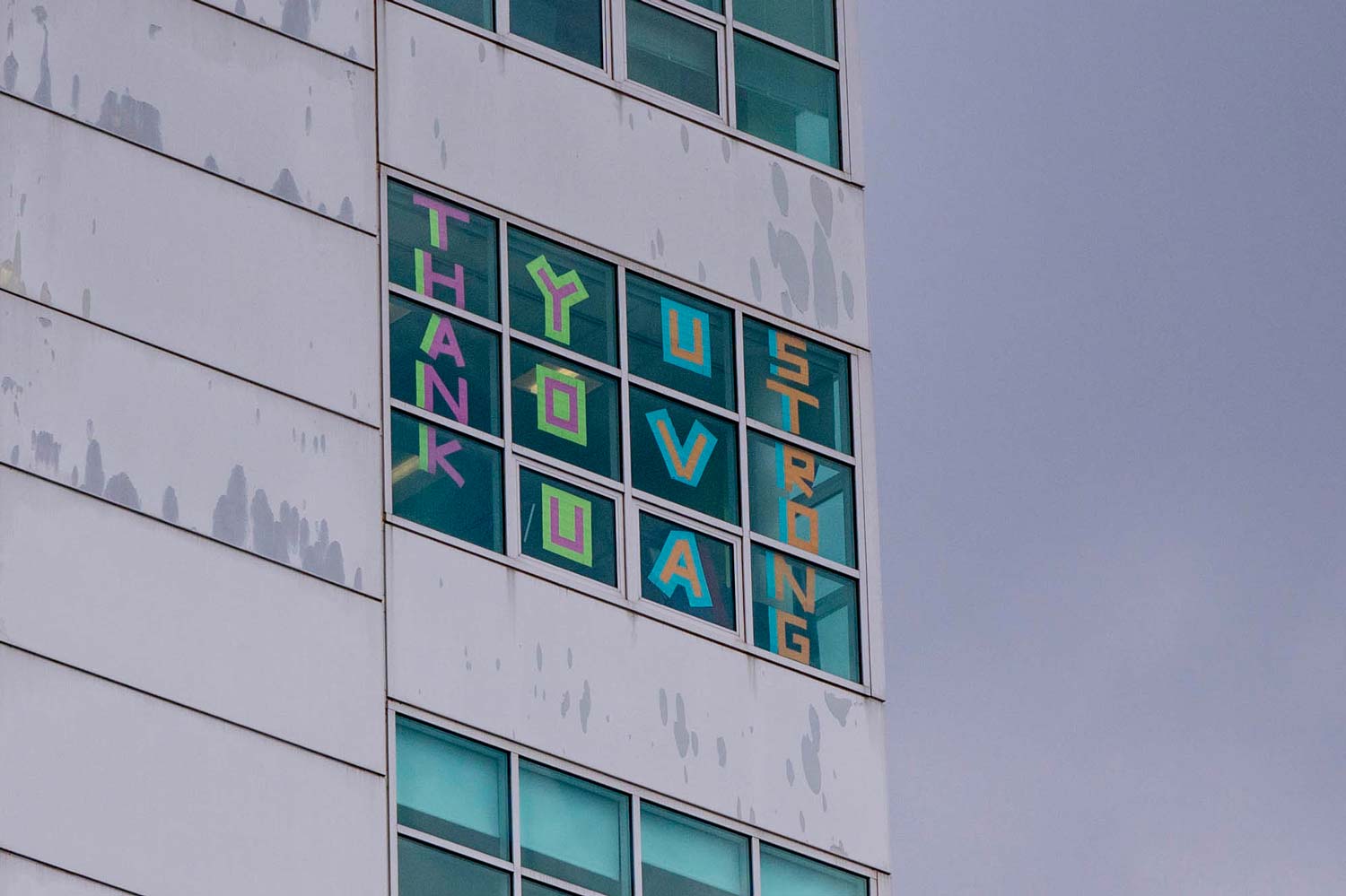 Window in building that reads: Thank you UVA strong