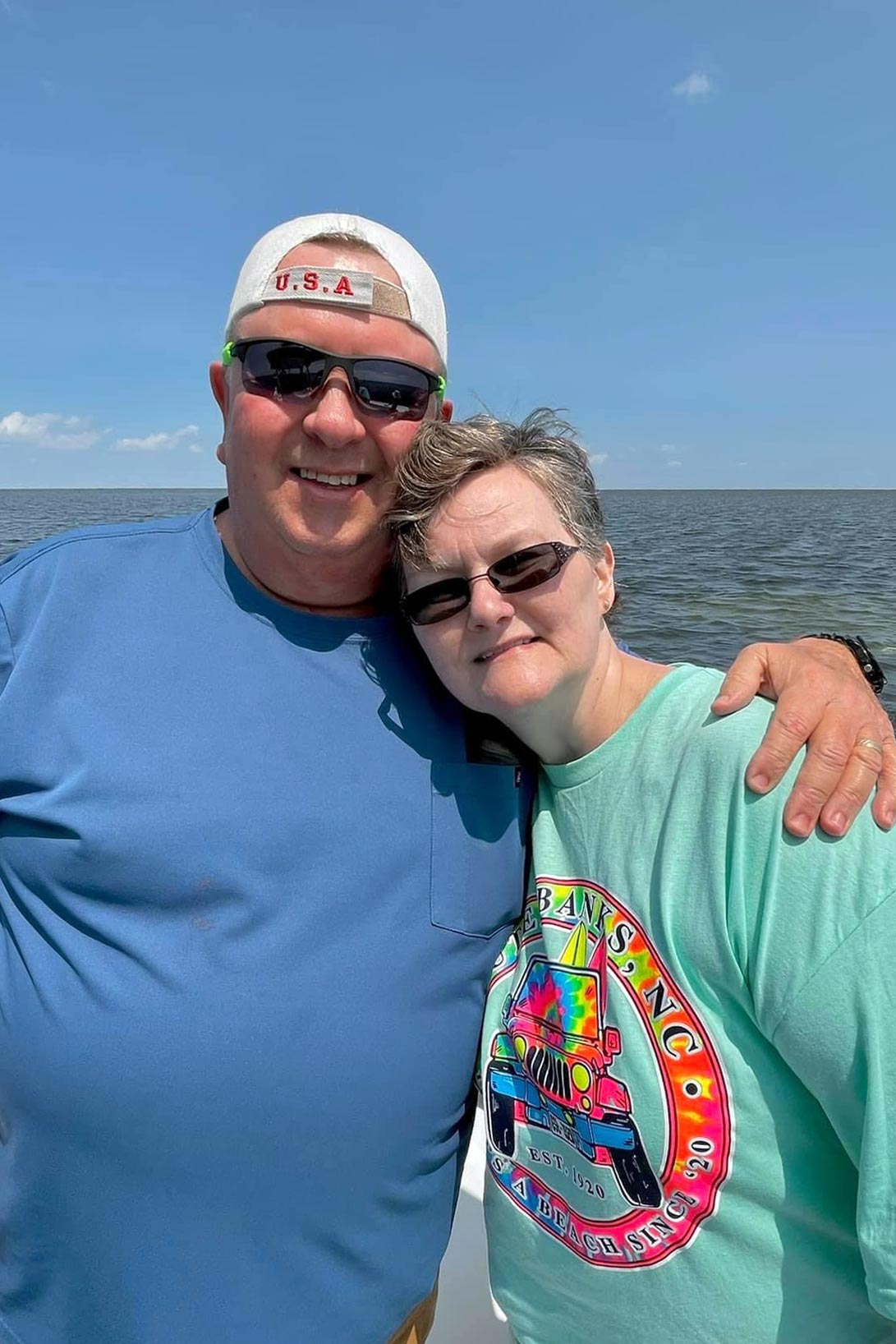 Wendy Conner poses with her husband Don, for a picture on a boat