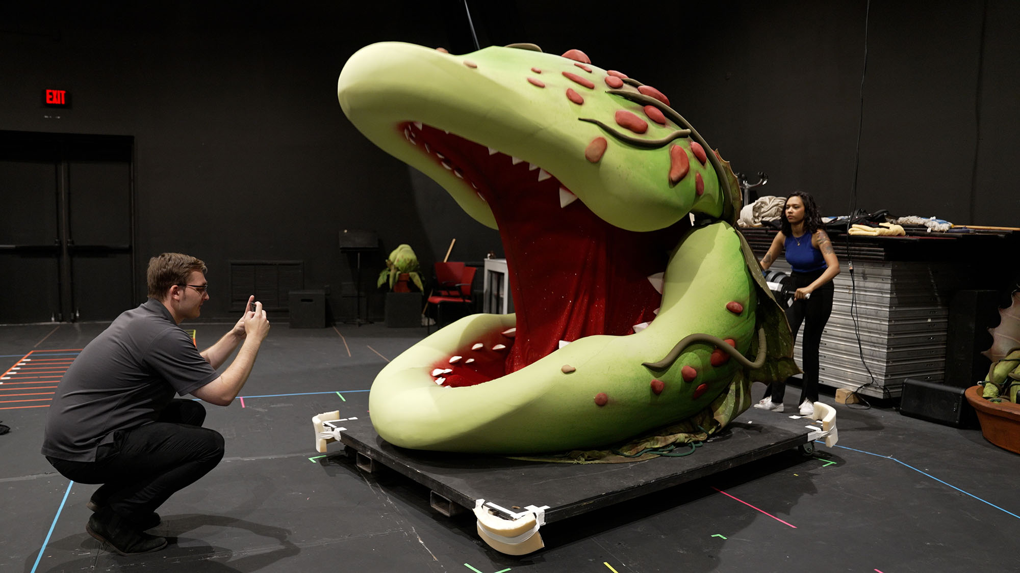 Person taking a picture of art at the Virginia Theatre Festival.