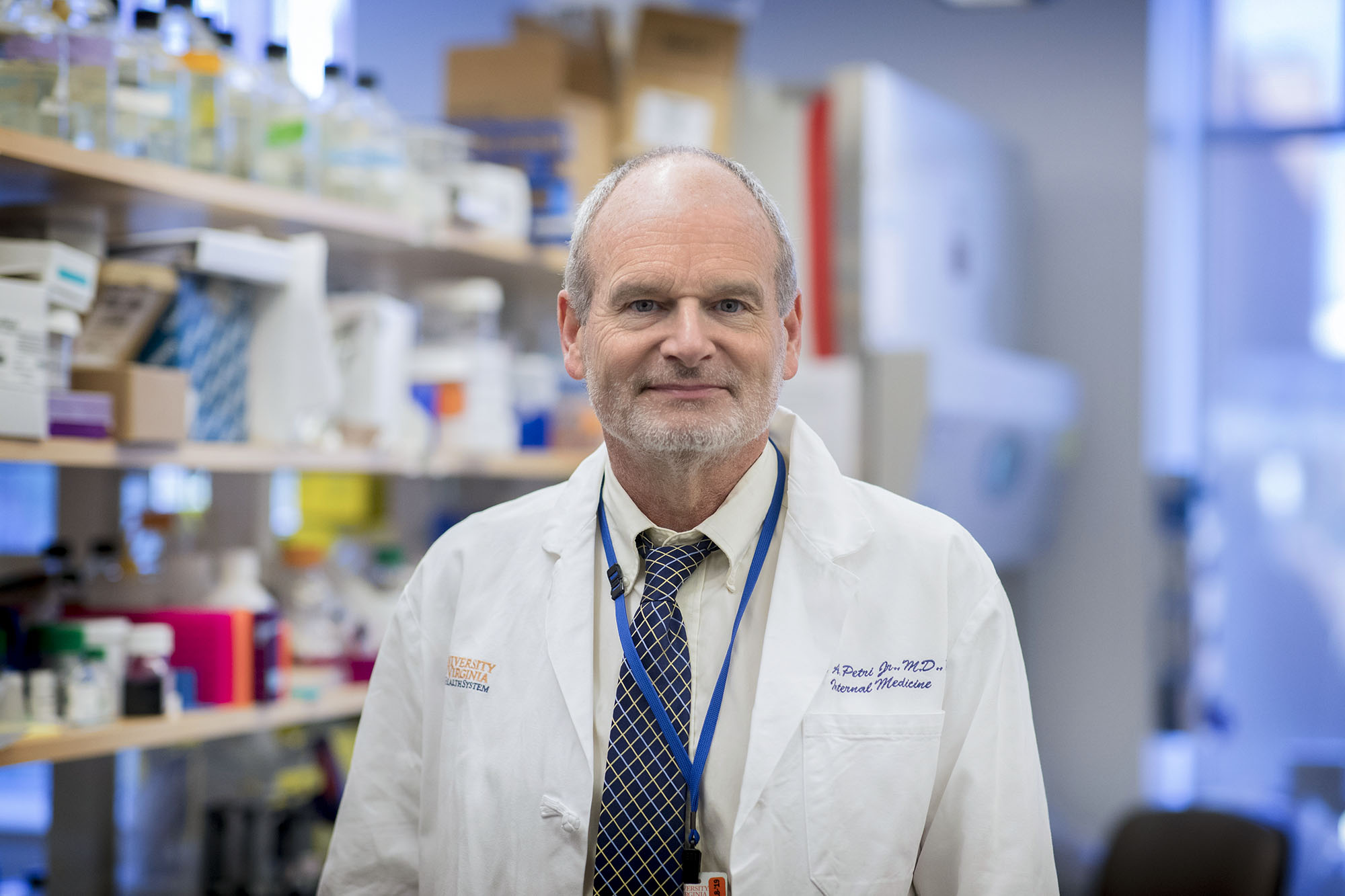 Dr. William Petri headshot in a lab