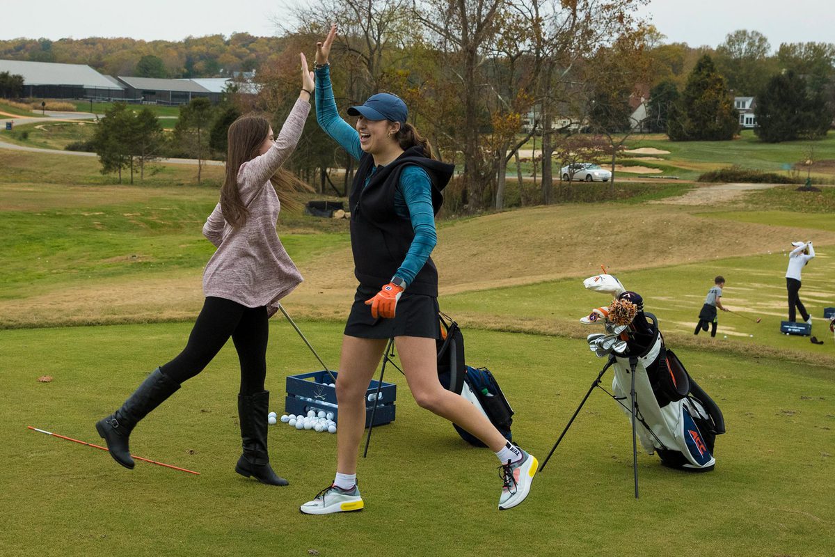 Sky Sload celebrates a good shot by giving Molly Harry a high five