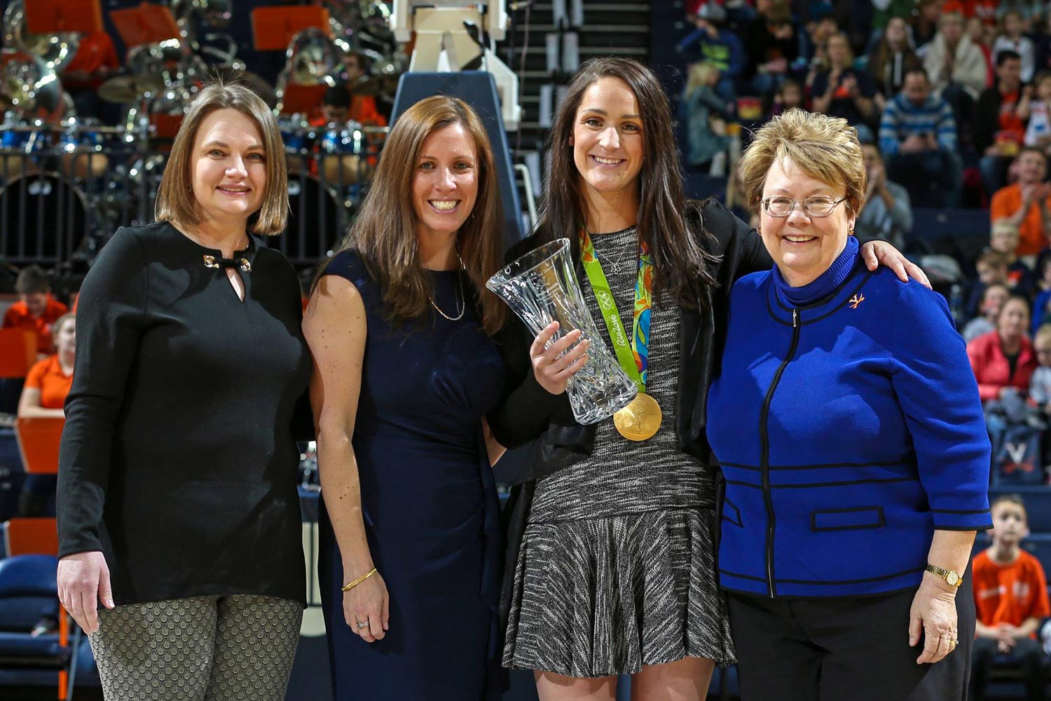 Gold medalist Leah Smith, center, was honored at the National Girls and Women in Sports event in February, with, from left, Women’s Center Director Abigail Palko, Valerie Richardson of Athletics and UVA President Teresa A. Sullivan. (Photo by Matt Riley)