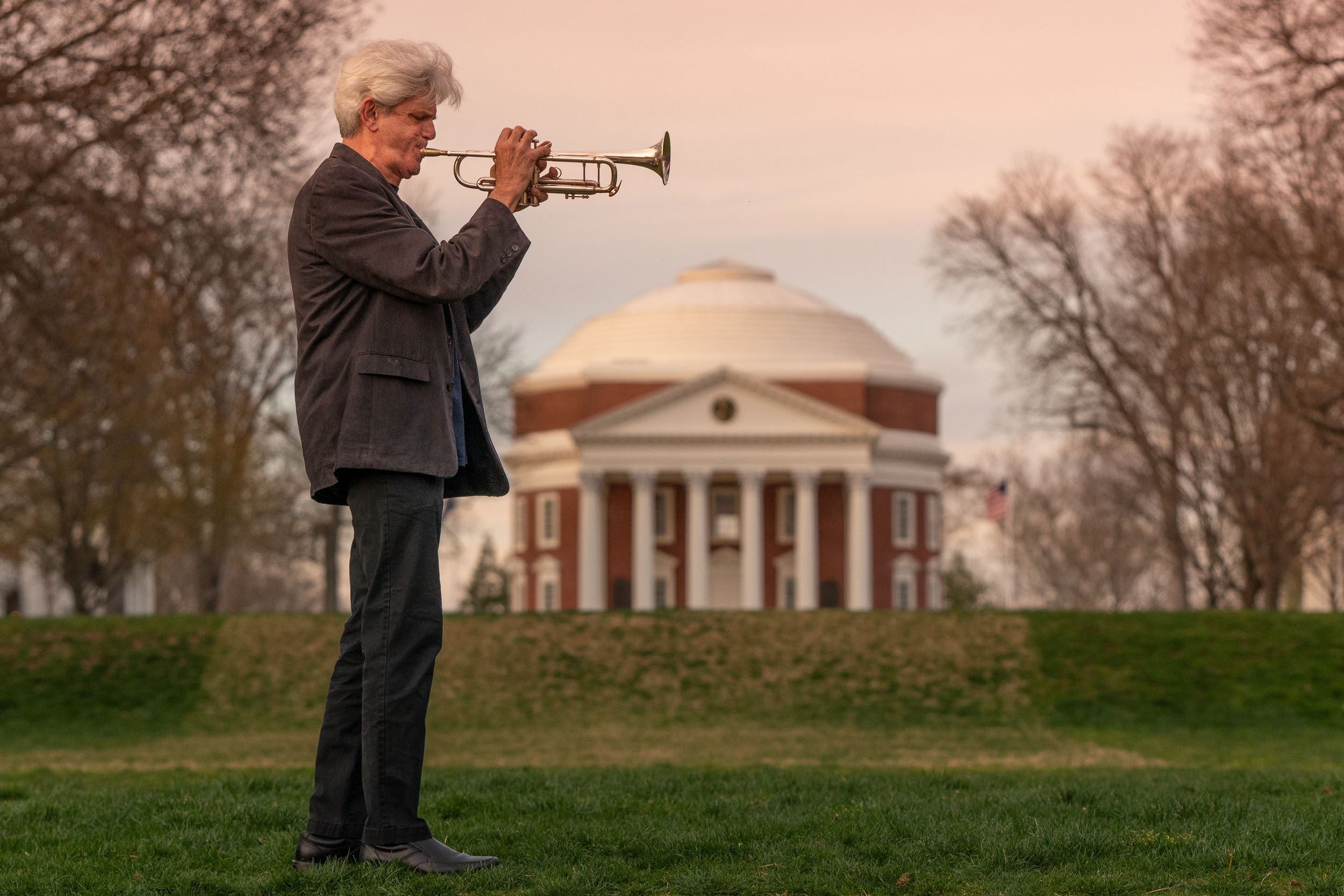 Man playing the trumpet in front of the Rotunda