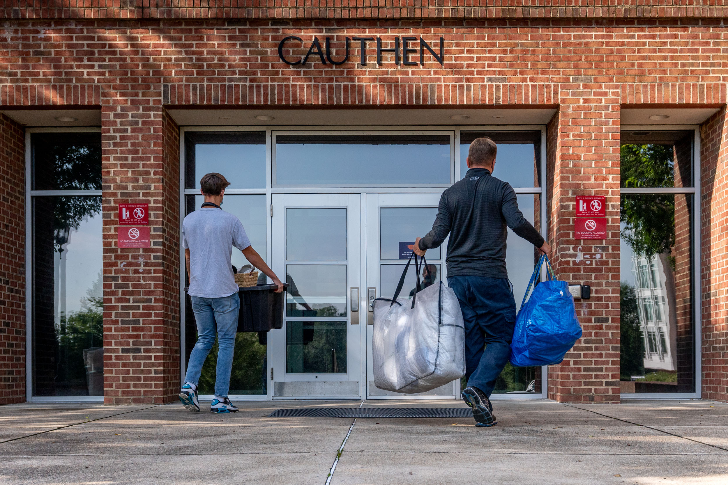 Two men making deliveries to the Cauthen building
