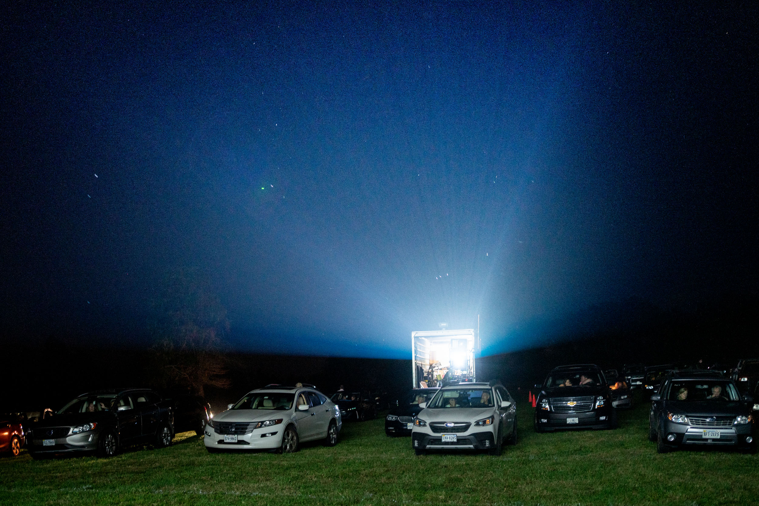 Project on a box truck shining out over the cars waiting for the drive-in to start