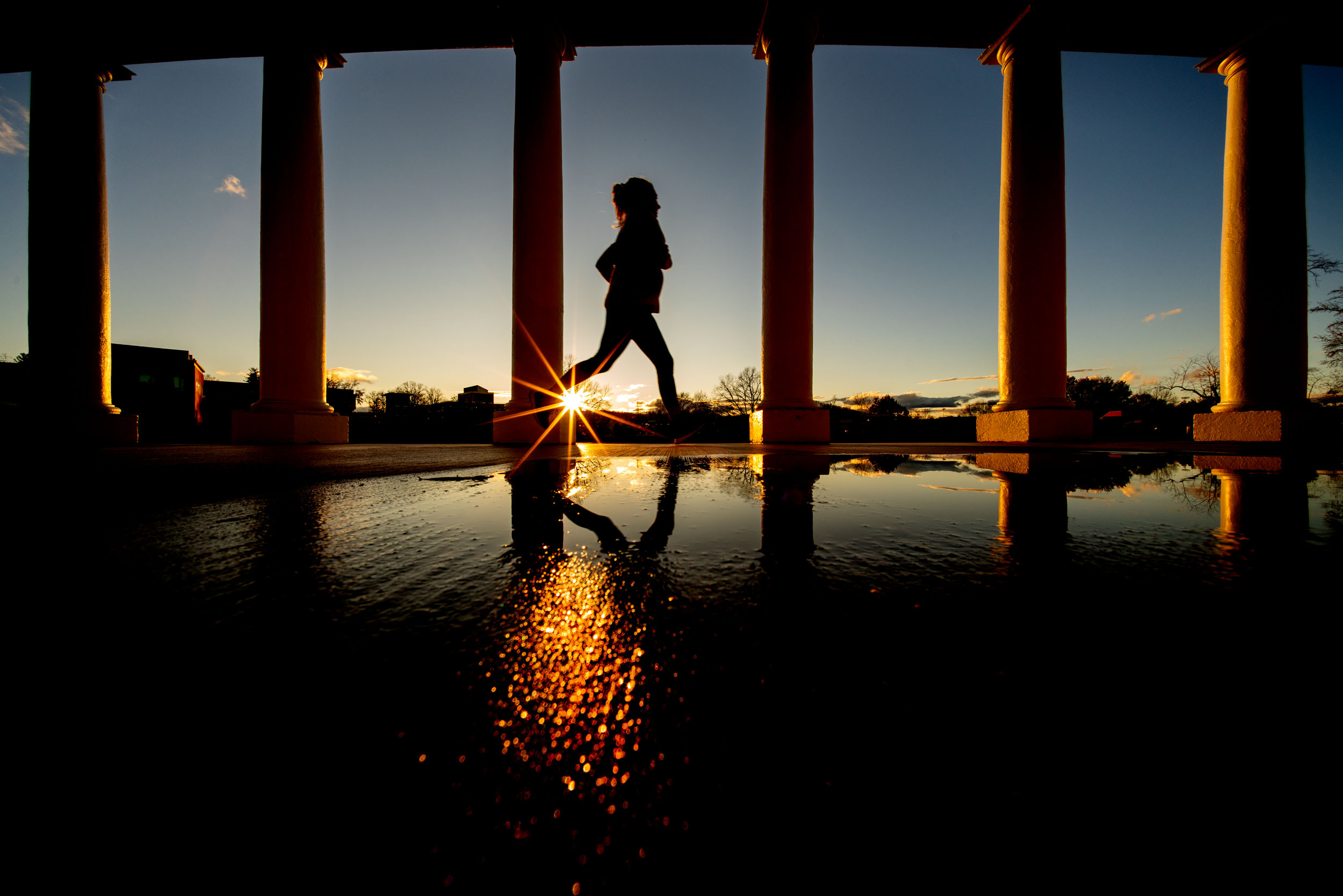 Woman running through the columns on Grounds