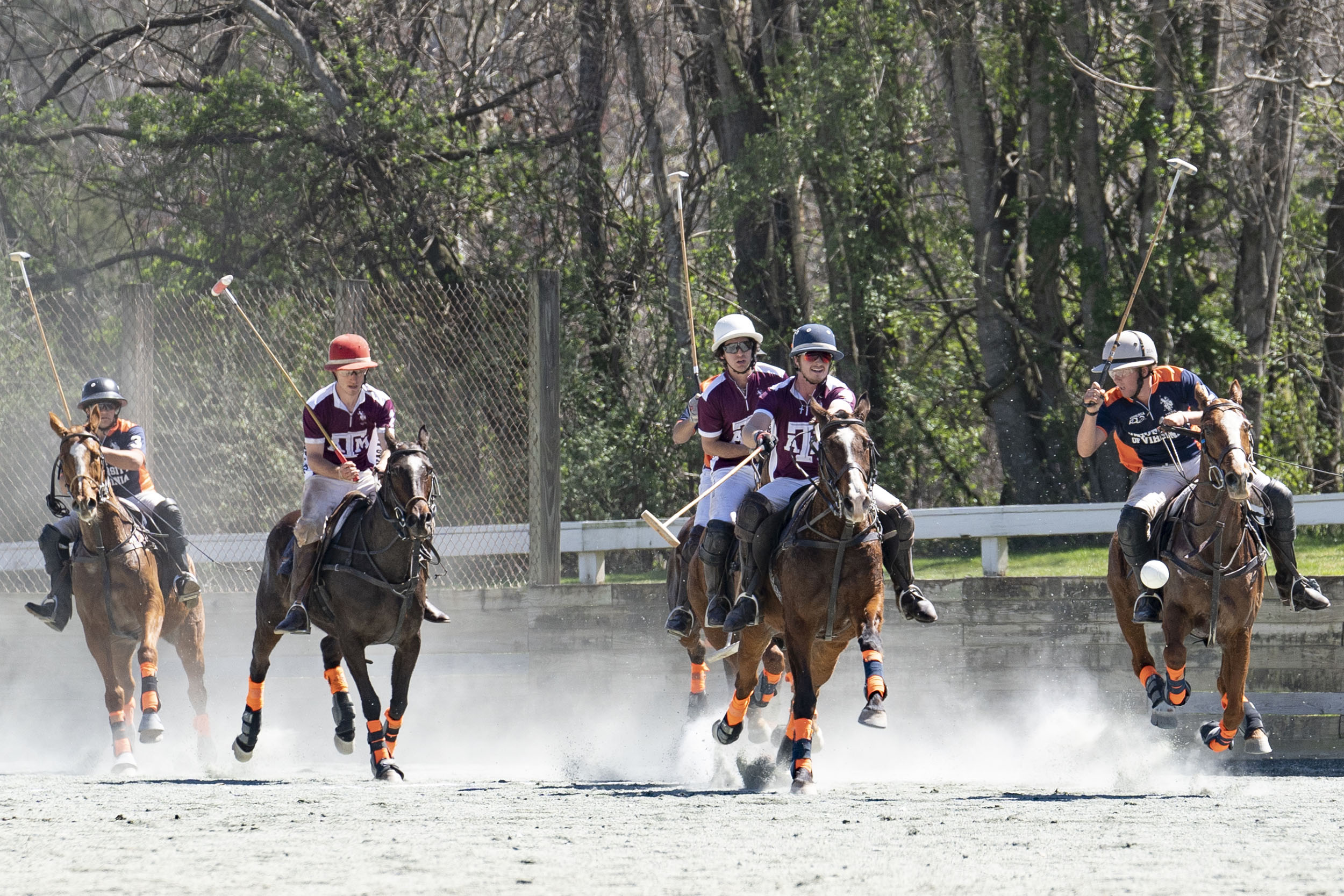 Cavalier Jim Deal, right, hits the ball away from with three Texas A&M players.