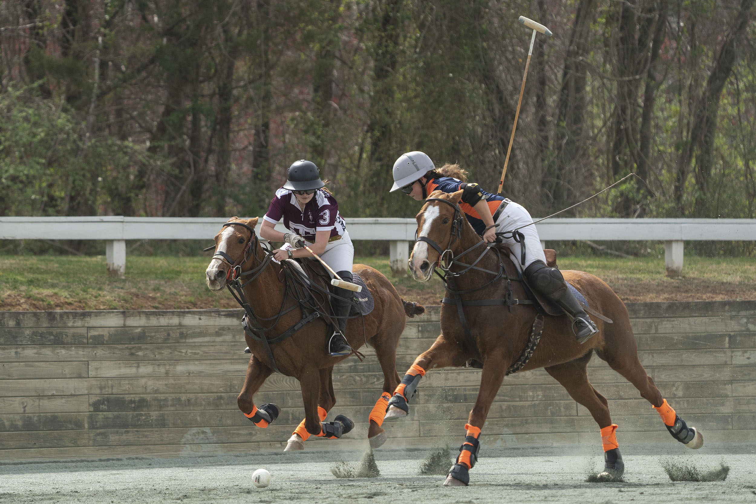 Alana Benz prepares to swing at the ball while a Texas A&M player tries to block