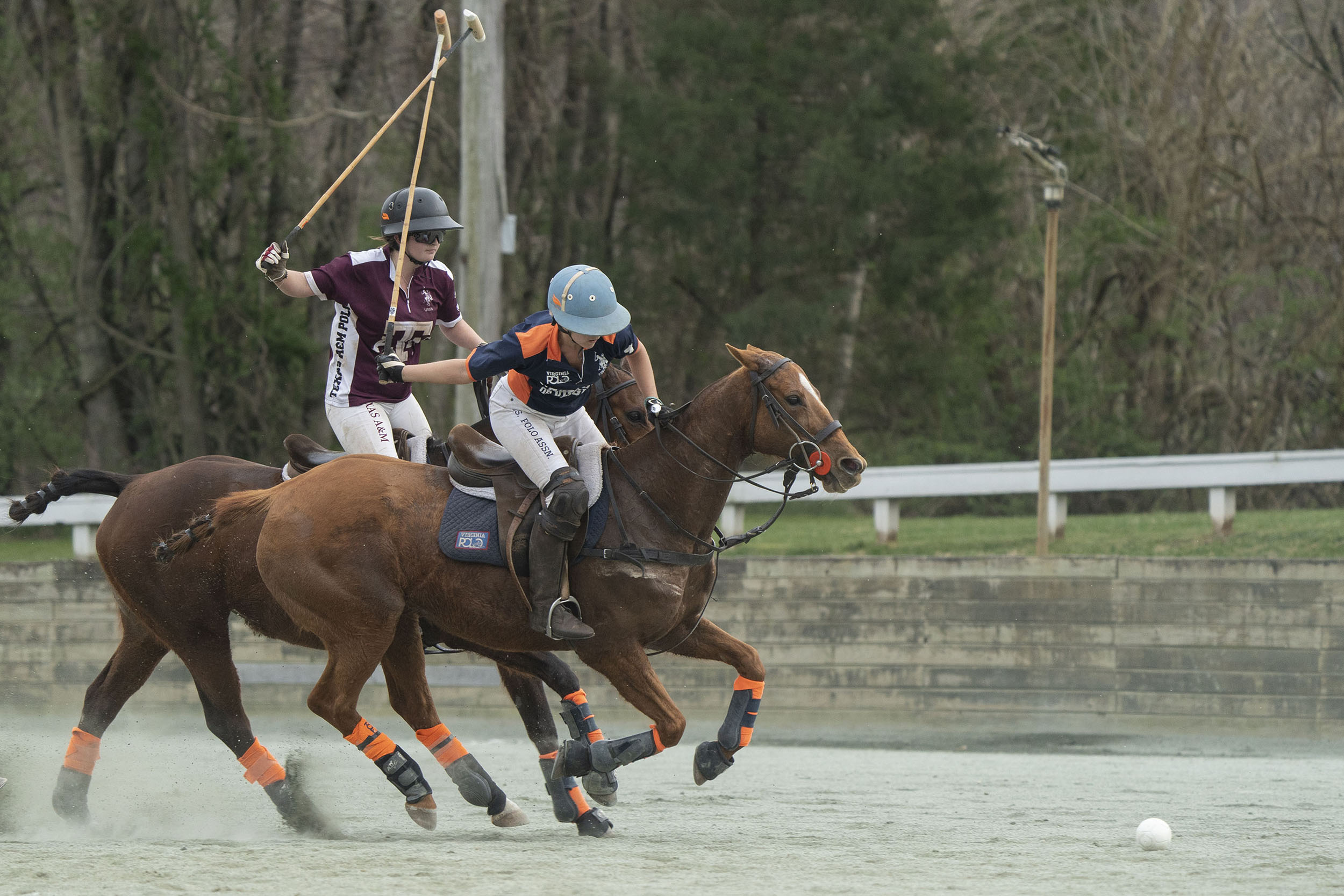 Katie Define prepares to swing at the ball while being pursued by a Texas A&M player during a recent match